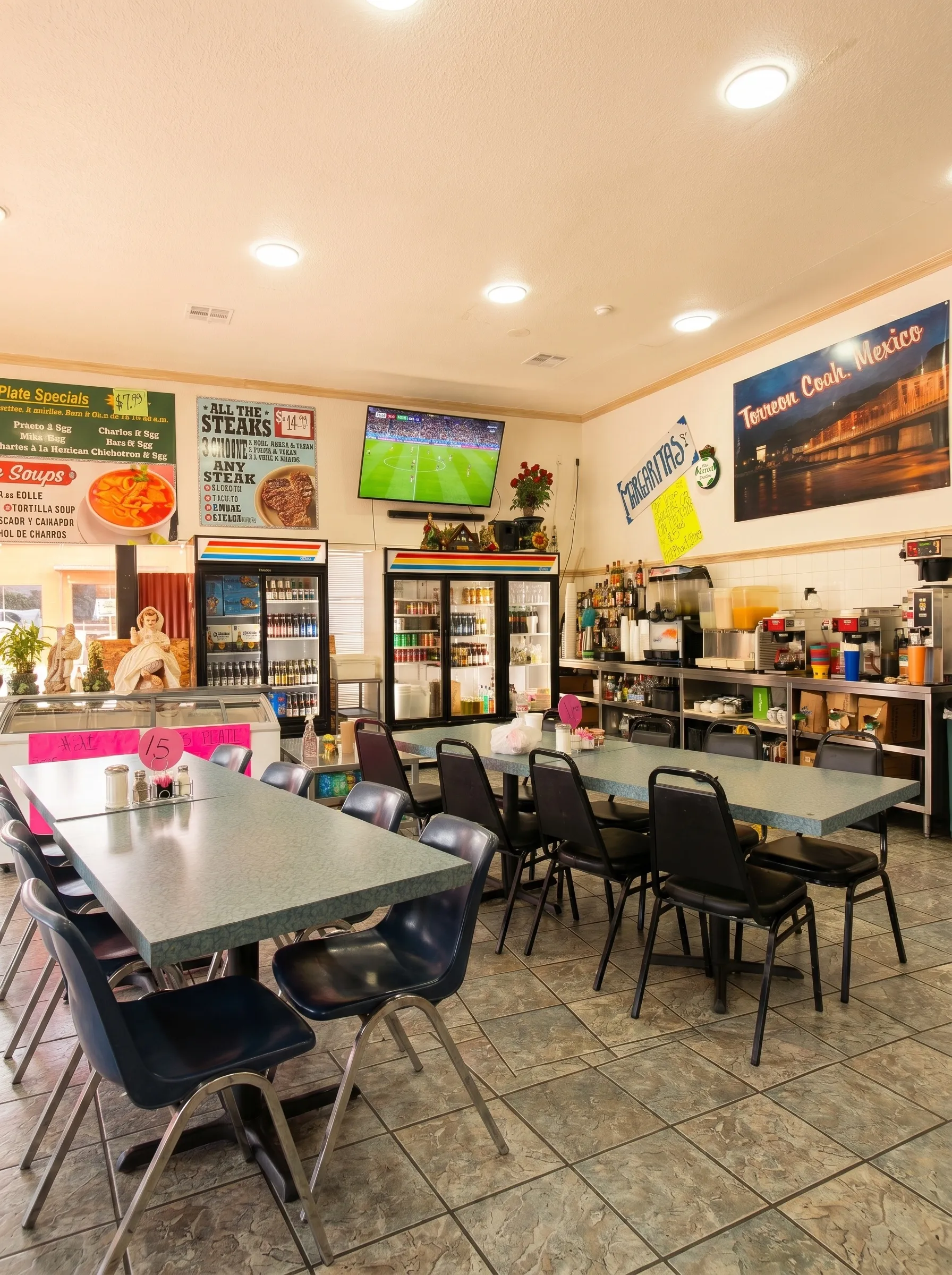 El Torreón interior with steam table, Torreón Coahuila Mexico tower mural, and soccer on TV