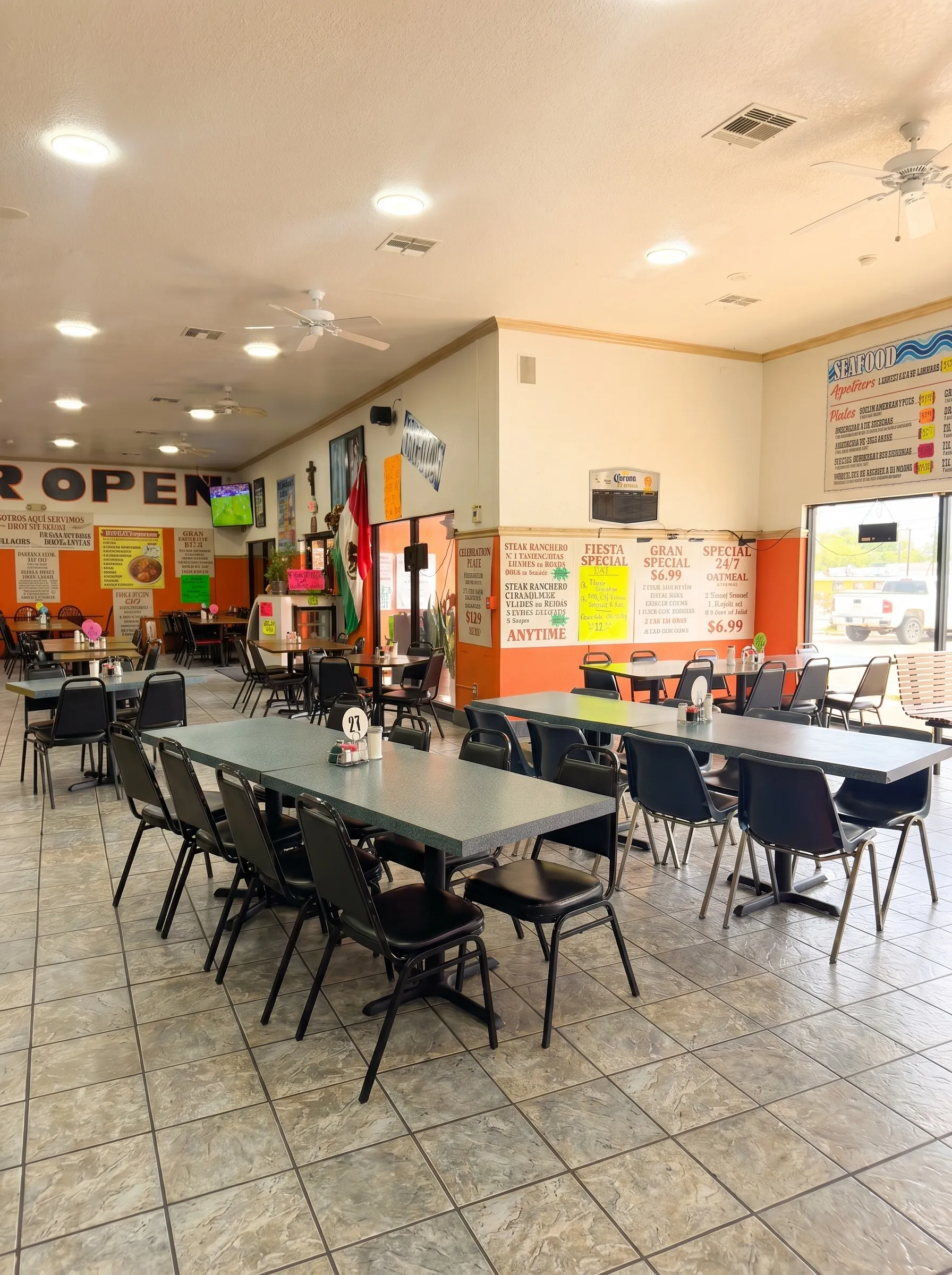 El Torreón wide interior view with Mexican flag, Bar Open wall, and specials including Steak Ranchero and Fiesta Special